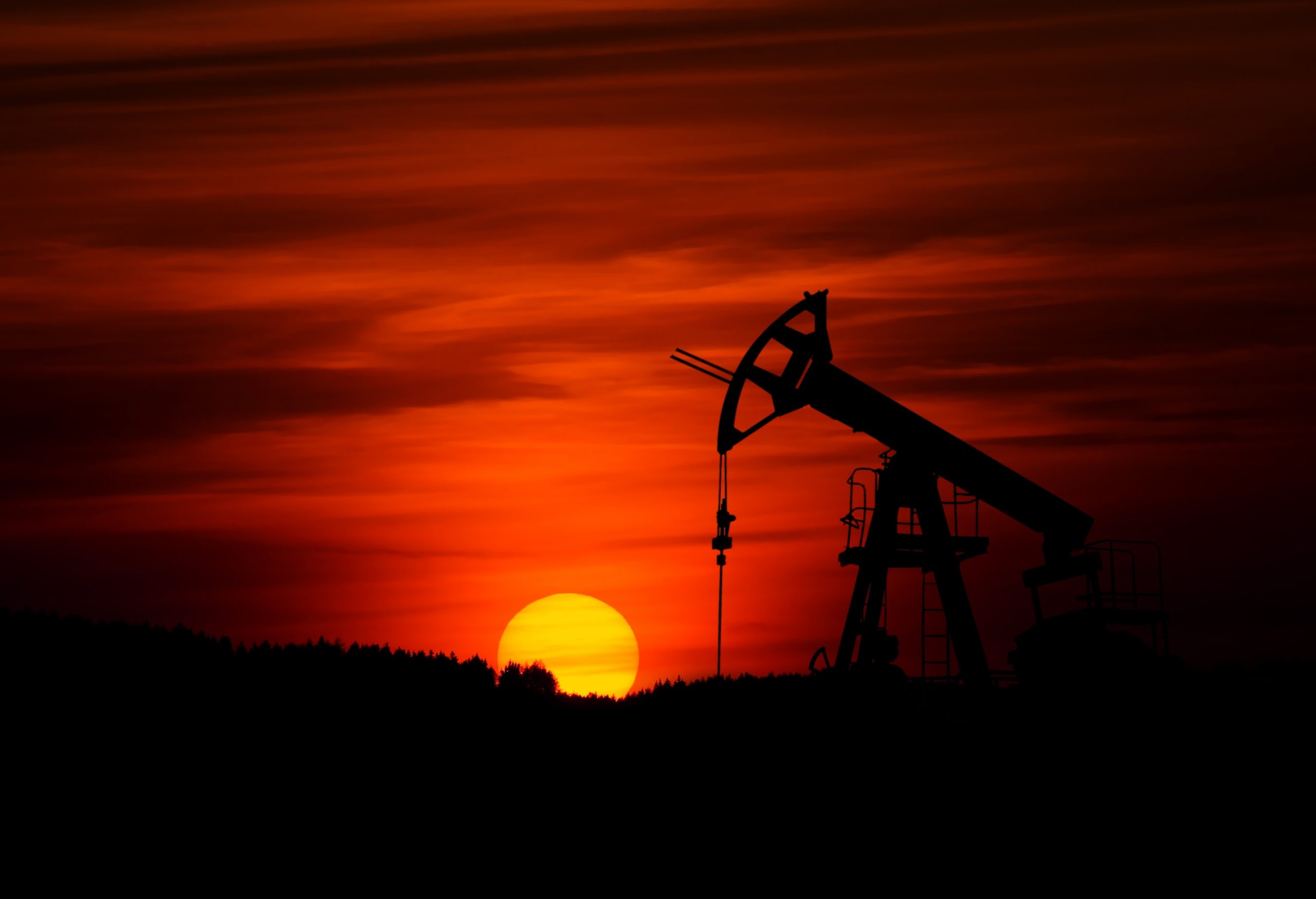 sunset behind oil and gas equipment