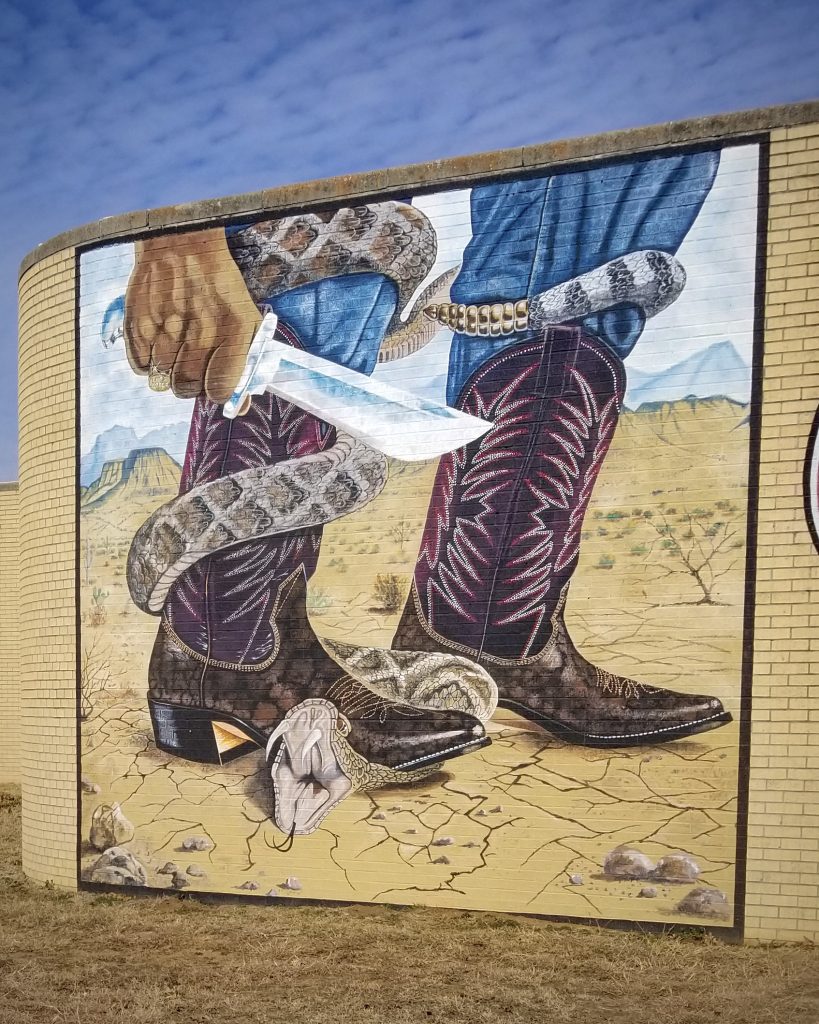 A Nocona boot stomping down the threat of a rattlesnake
