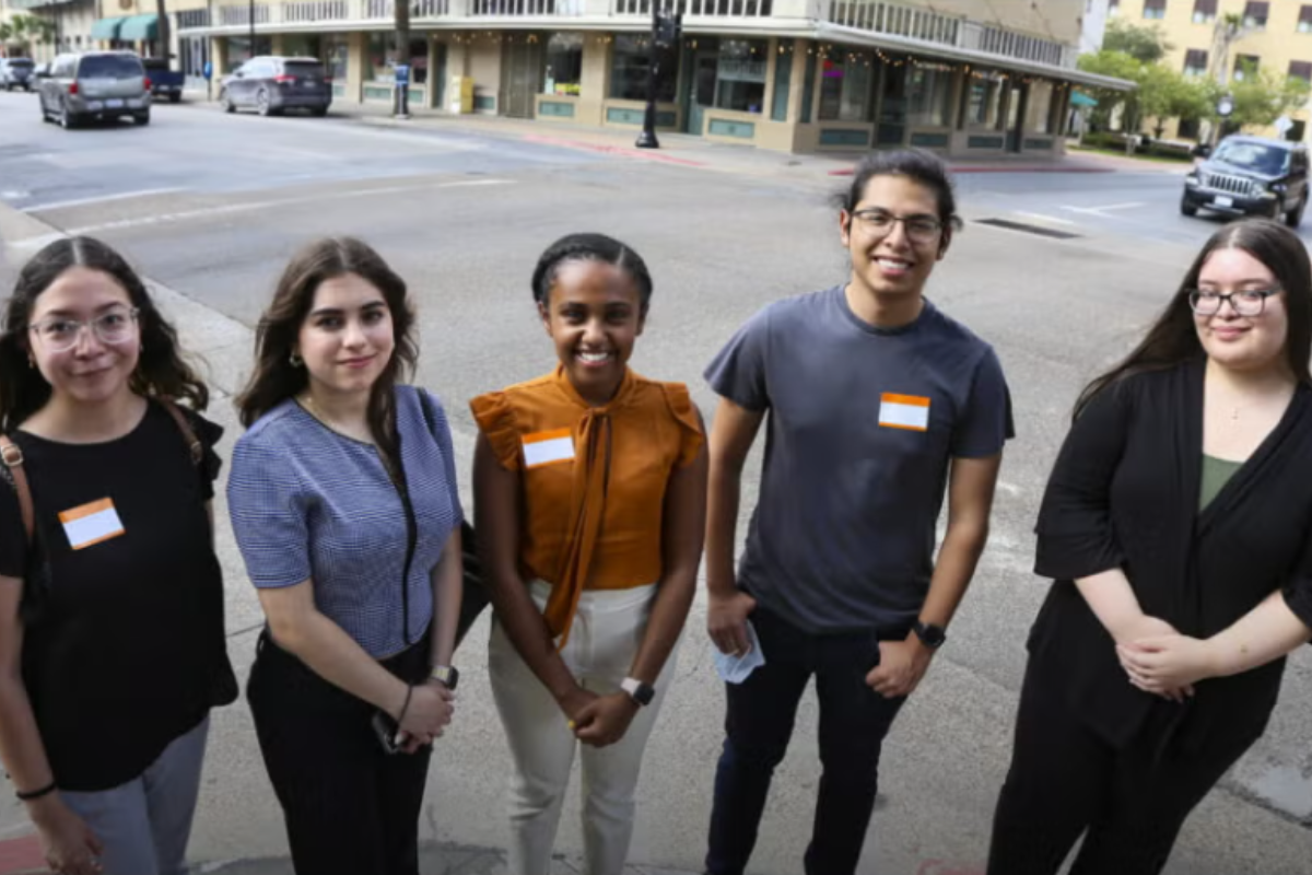 Brownsville Home to Texas Students stand on downtown sidewalk.