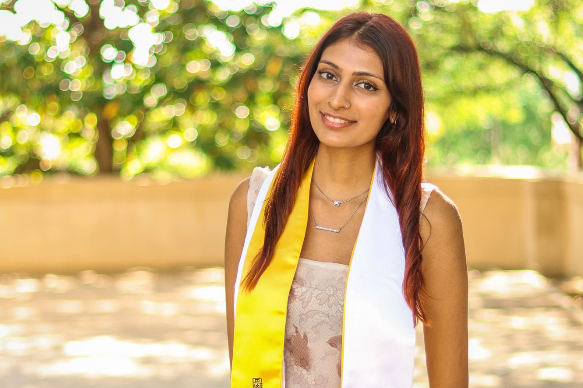 Health researcher and aspiring med student, Ishani Purohit in graduation robe.