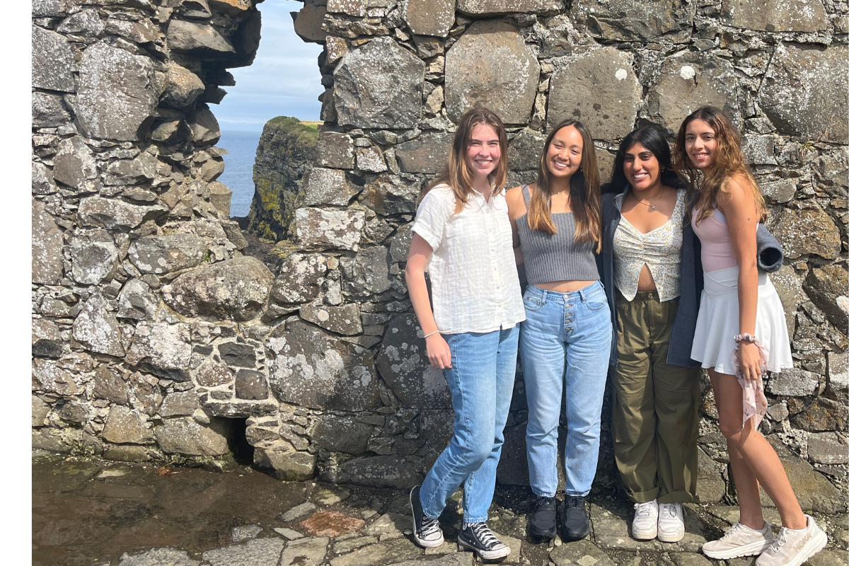 Four students stand in front of wall in Northern Ireland