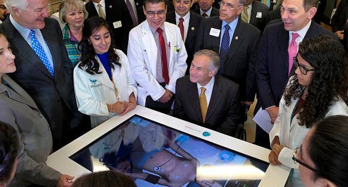 Texas Governor Greg Abbott and officials with Body Interact table